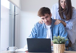 A couple checking their insurance coverage online