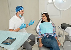 Happy dentist and patient engaged in conversation