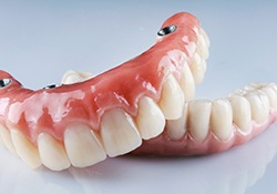 A closeup of two implant dentures